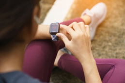 After a run, a woman checks her Apple Watch heart rate monitor to get an accurate reading.