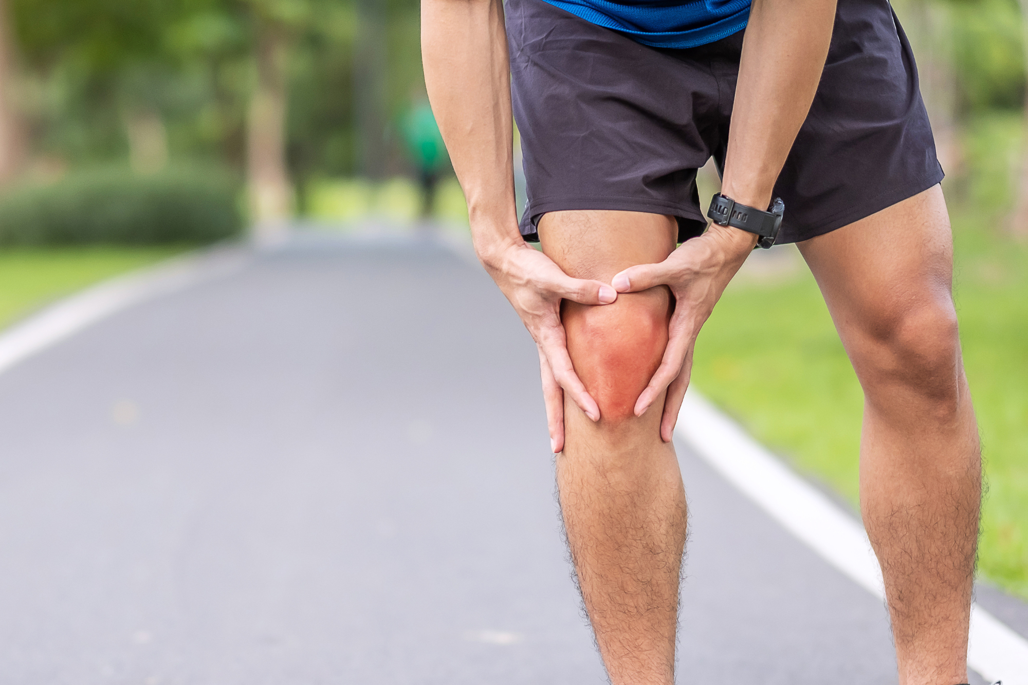 A runner on paved path holds his knee after feeling a sharp pain, wondering, “Does a meniscus tear need surgery?”