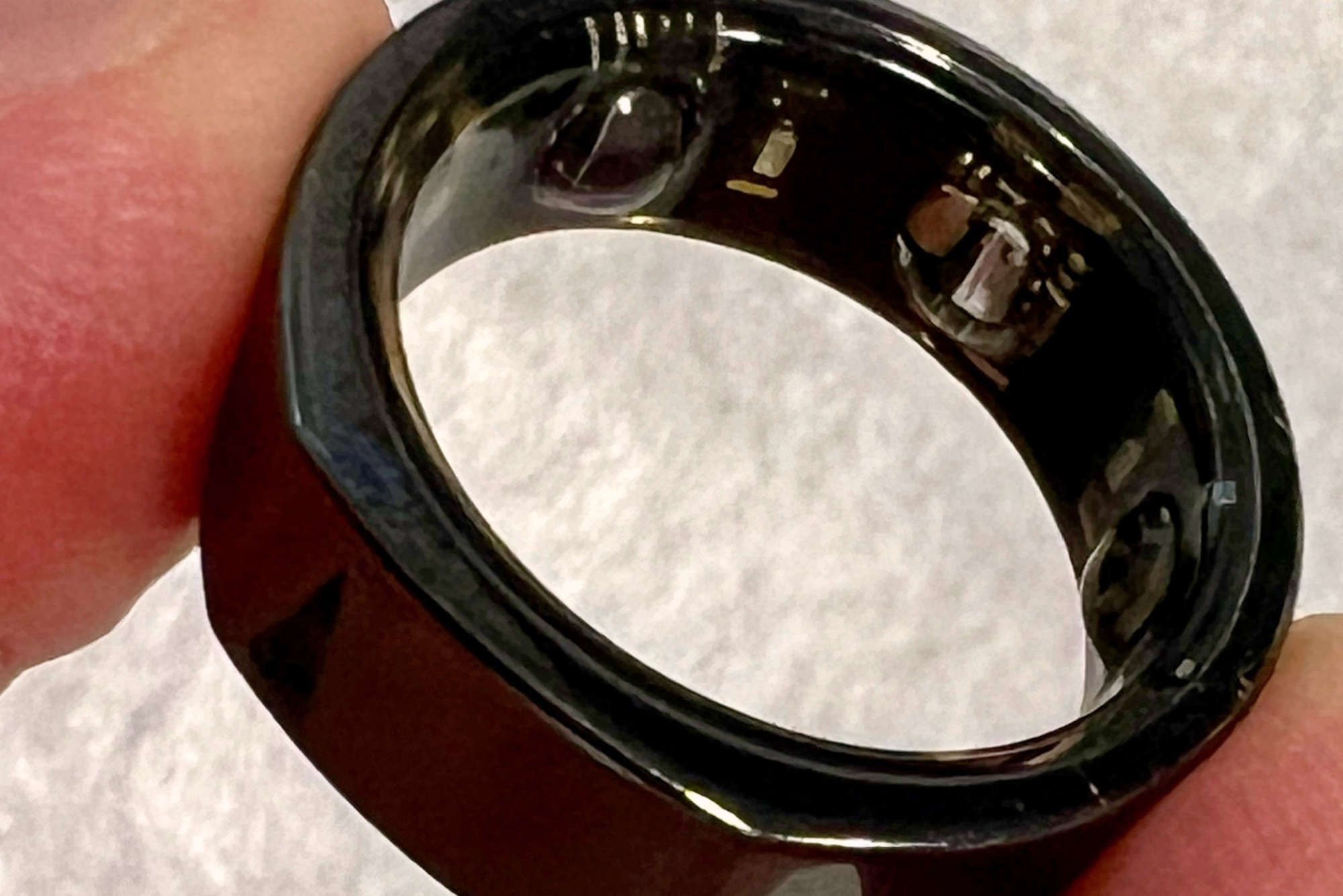 A close-up shot of a black Oura Ring.