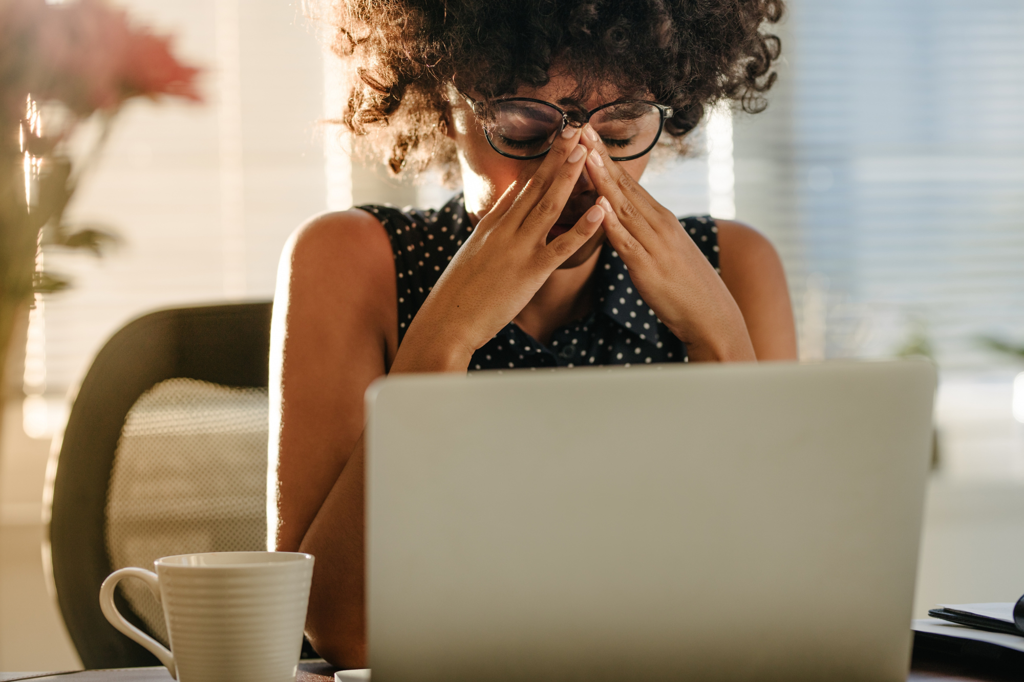 A woman sits in front of her laptop, after researching what do studies show about the relationship between stress and memory.