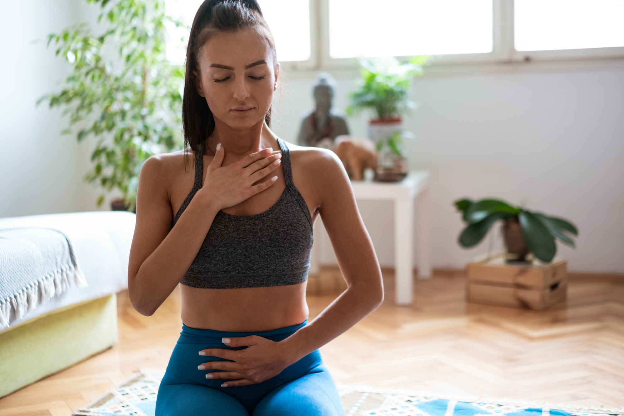 Young woman practicing mindful belly breathing at home.