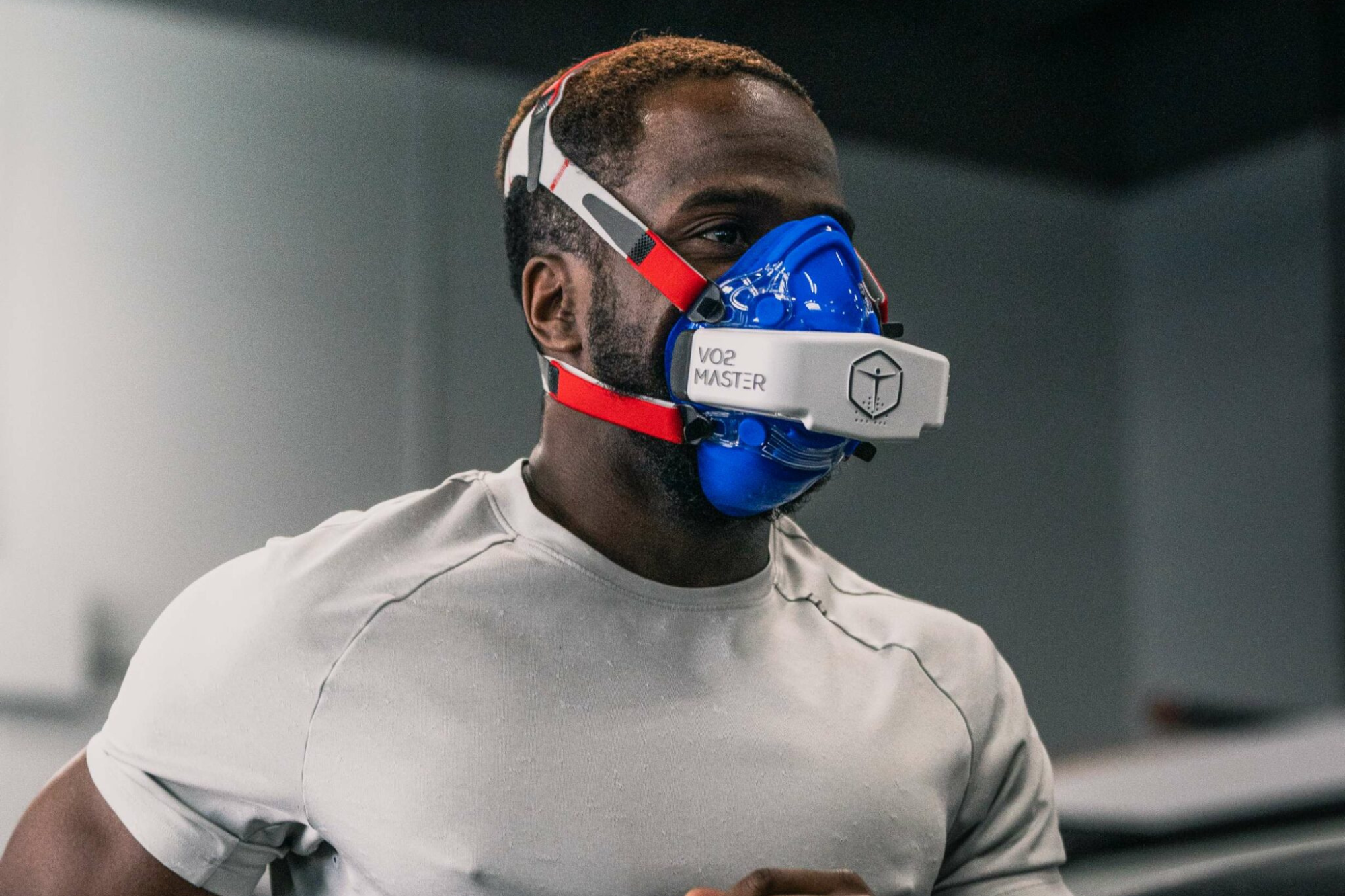 A man wearing VO2 max mask during cardio fitness testing in sports lab.