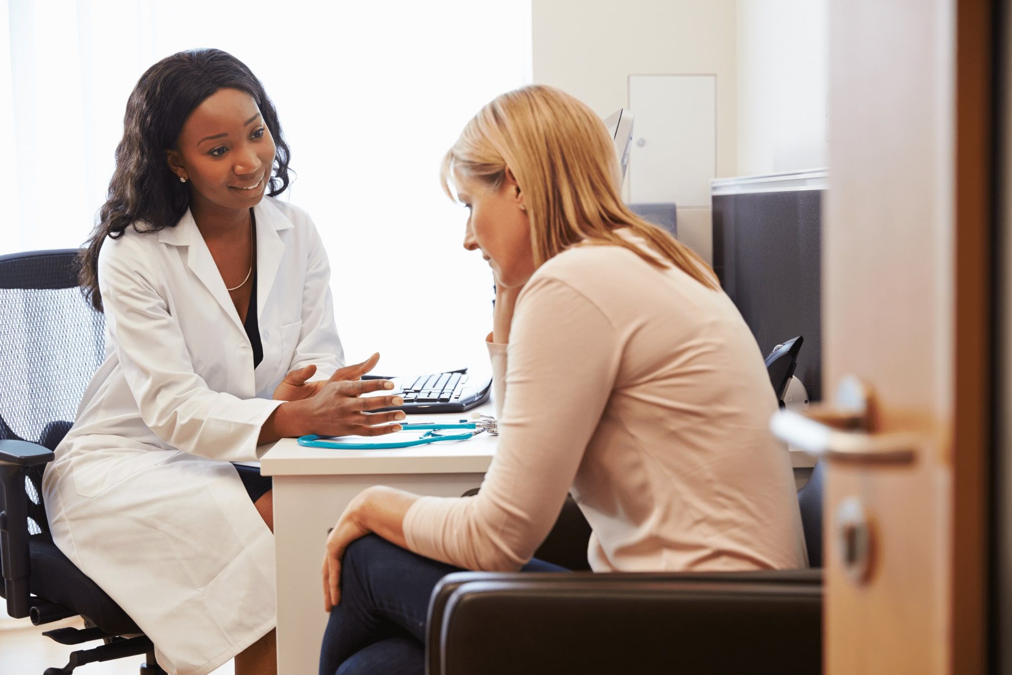 Female doctor counseling patient in office about women’s health issue.