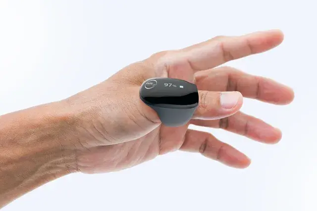 A hand wearing a small sleep‑tracking ring on the thumb, used for monitoring sleep apnea without CPAP.